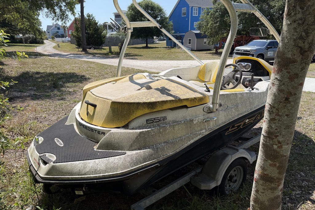 Sea-Doo jet boat before soft washing — algae and waterline grime on the hull, coastal Brunswick County NC