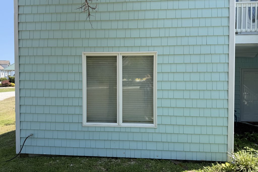 Coastal home shake siding after soft washing — algae gone, color restored